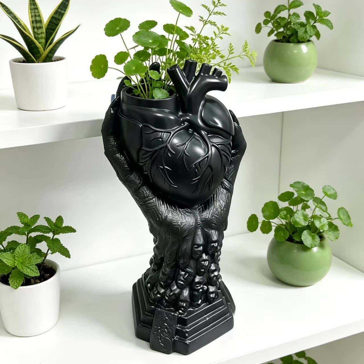 The Heartkeeper Planter, Midnight Heart, planted with greenery on a shelf