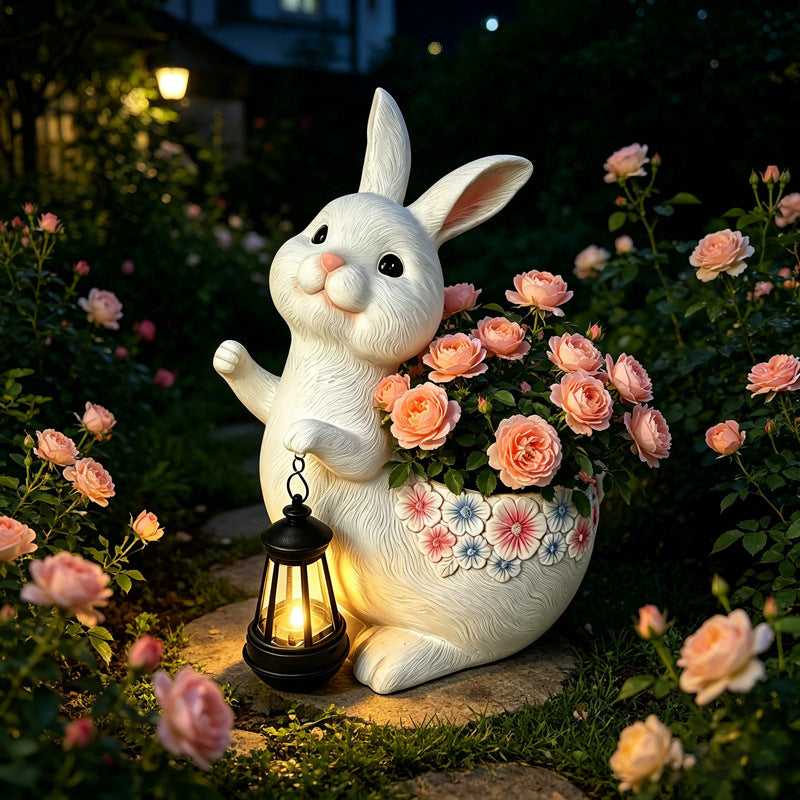 The Lantern Rabbit Planter — a rabbit garden planter holding a lantern, planted with roses