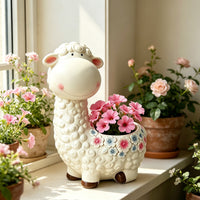 The Little Meadow Sheep Planter — a sheep-shaped planter with sculpted curls, planted with pink flowers