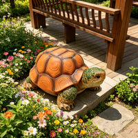 The Old Garden Turtle Stool — a large turtle-shaped garden stool beside a bench and flower bed