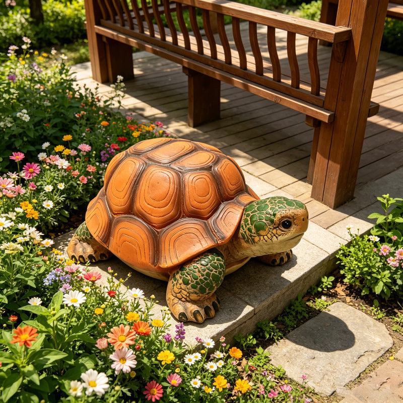 The Old Garden Turtle Stool — a large turtle-shaped garden stool beside a bench and flower bed